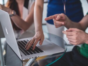 computer and people around discussing SEO strategies